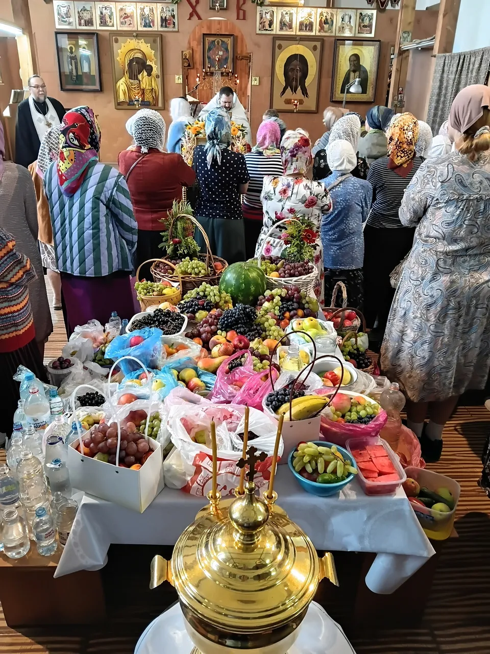 Прихожане с корзинами фруктов в очереди на освящение плодов